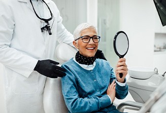 Senior woman smiling while looking at reflection
