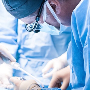 Dental team carefully performing oral surgery