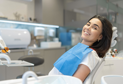 Woman smiling and leaning back in dental chair