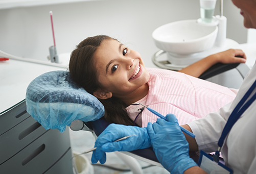Little girl lying back in dental chair