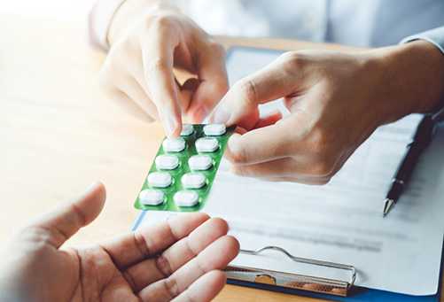 Handing patient antibiotics over a desk