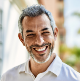 Man in collared shirt smiling