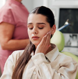 Woman with tooth pain at dentist's office