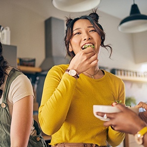Group of friends enjoying meal in kitchen