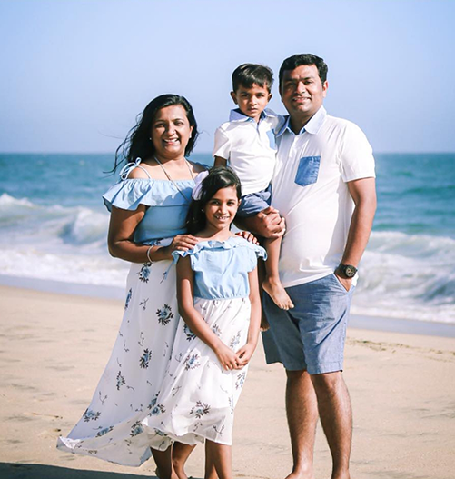 Dr. Jayswal with her family on a beach