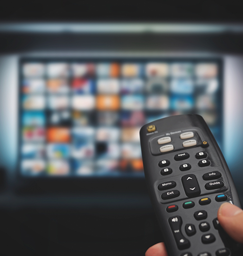 Using remote to change channels on TV screen