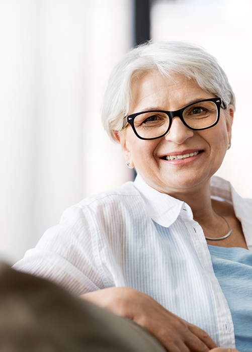 Senior woman with glasses smiling