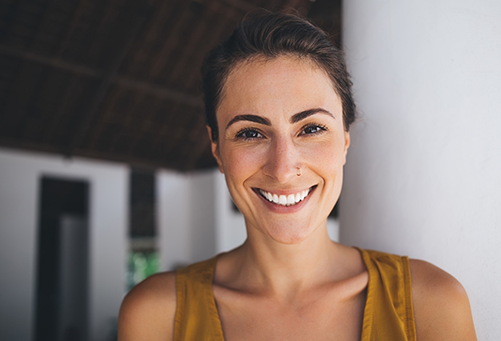 Close up of woman in brown shirt smiling