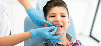 Young boy with braces in dental chair