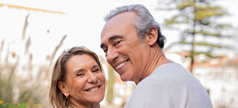 Older couple smiling together outside