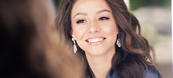 Smiling woman with shoulder-length wavy hair