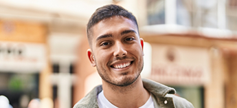 Man in city street smiling