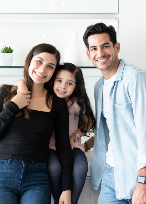 Man, woman, and little girl smiling