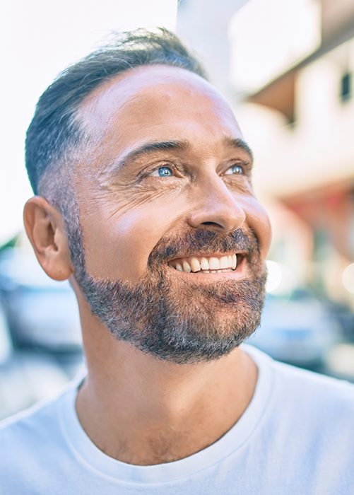 Close-up of bearded man smiling