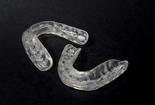 Two nightguards on a black surface