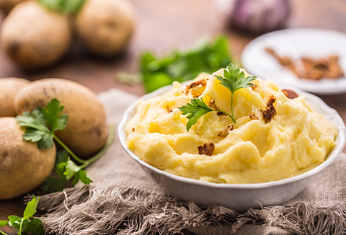 Bowl of mashed potatoes with a garnish